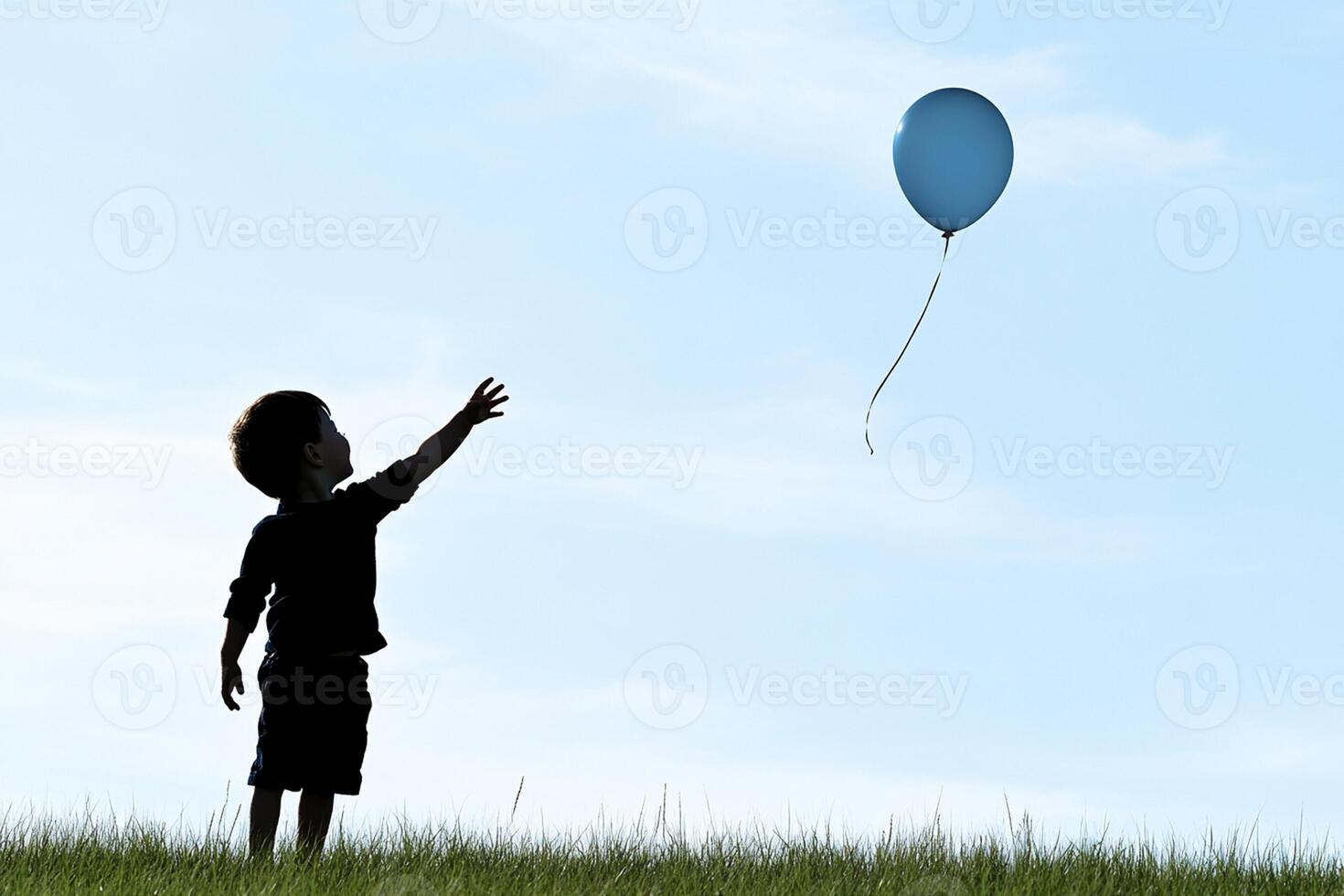 A child is flying a balloon in the sky photo