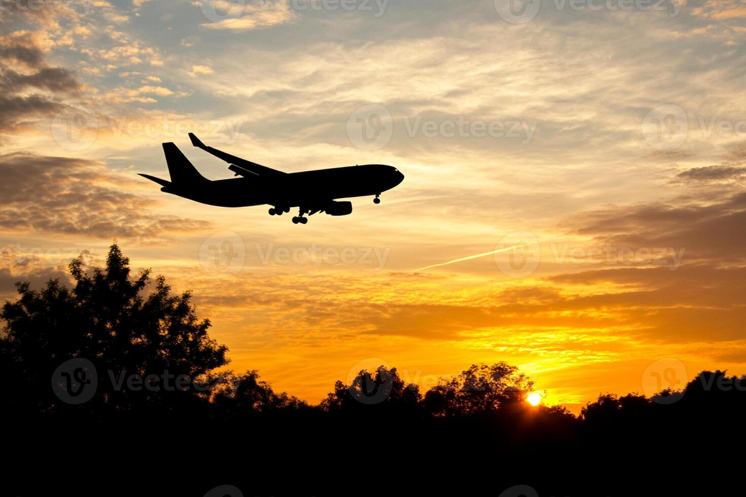 A plane flying in the sky at sunset photo