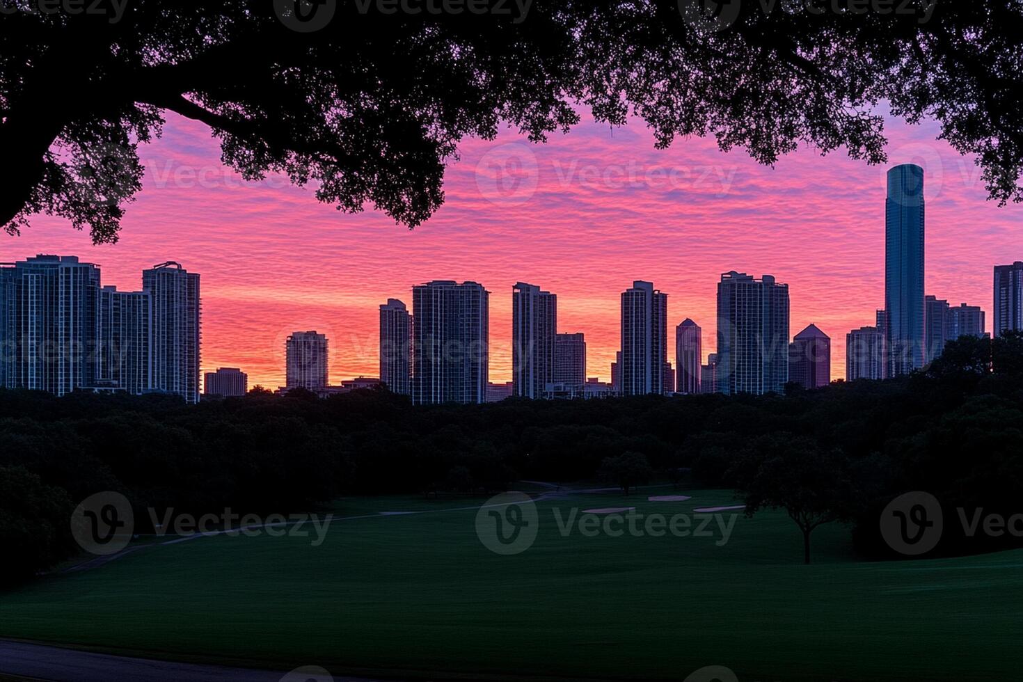 A city skyline at sunset with a golf course in the foreground photo