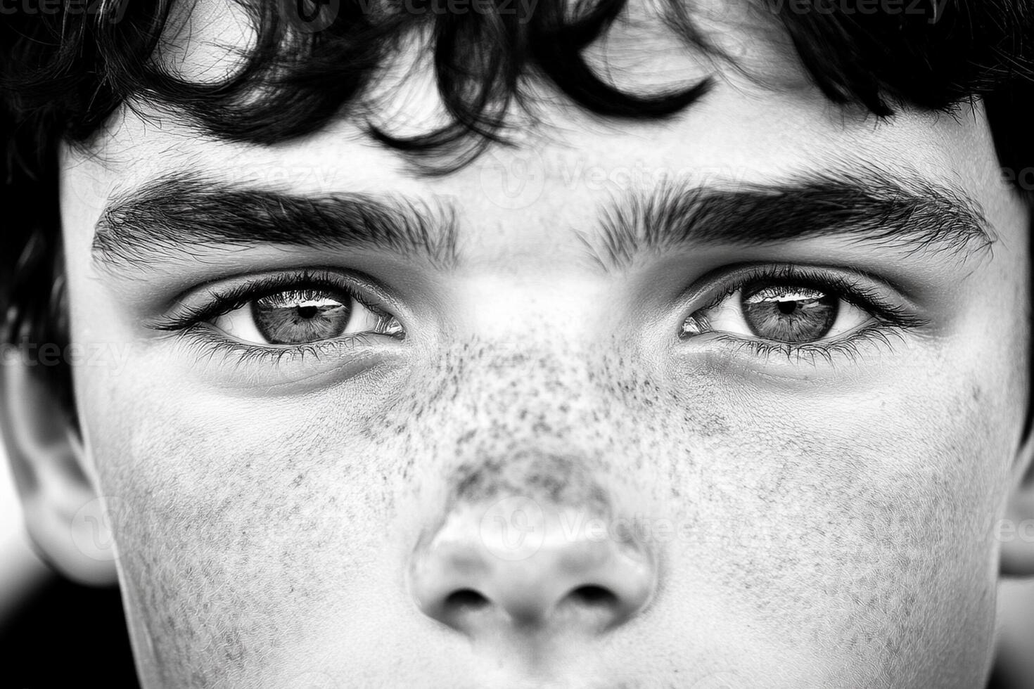 A black and white photo of a young boy with freckles