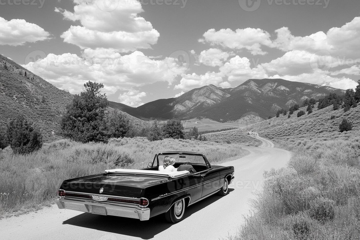 A black and white photo of a car driving down a road