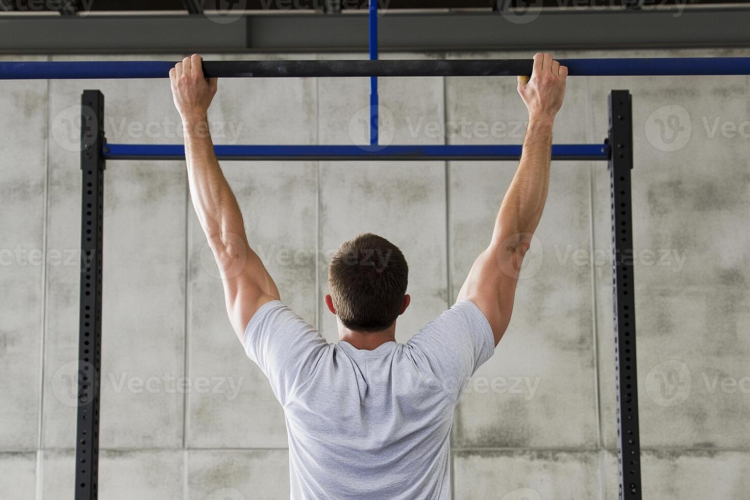 A man is doing pull ups on a pull up bar photo