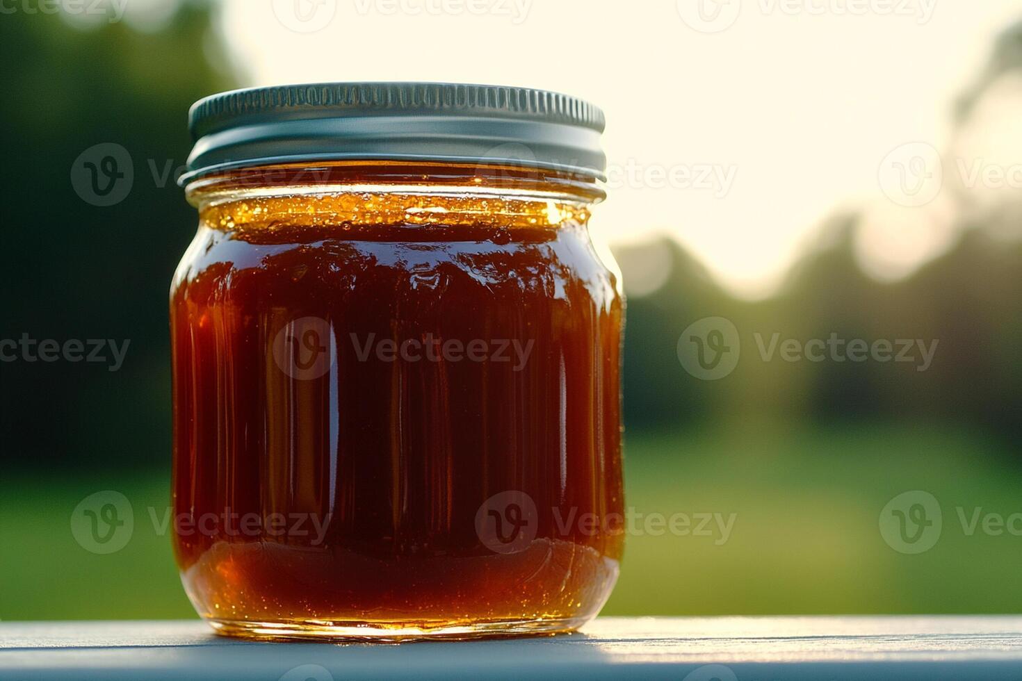 A jar of honey sitting on a table photo