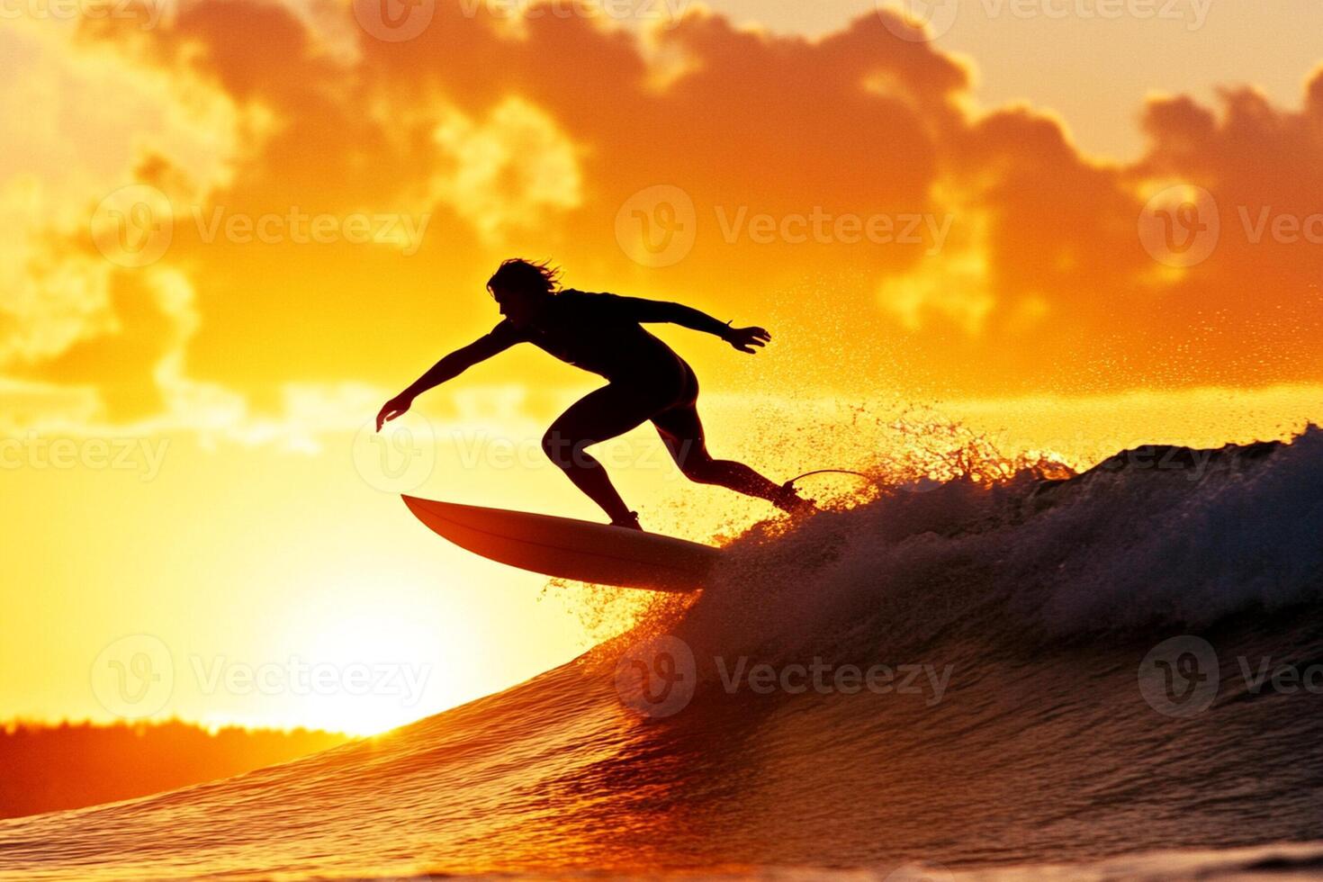 A man riding a wave on a surfboard at sunset photo