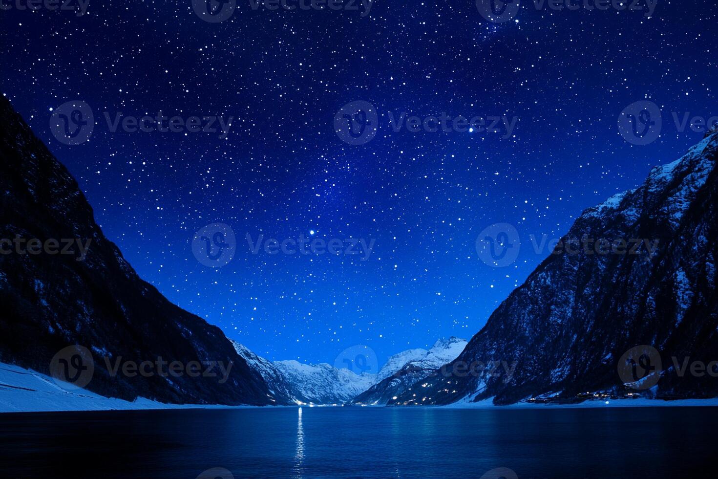 A lake is surrounded by mountains and stars photo
