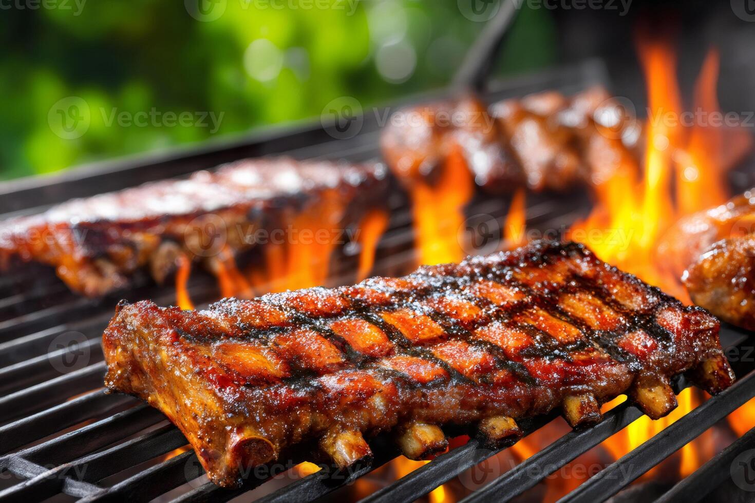 Delicious bbq pork baby back ribs grilling on a hot charcoal grill photo