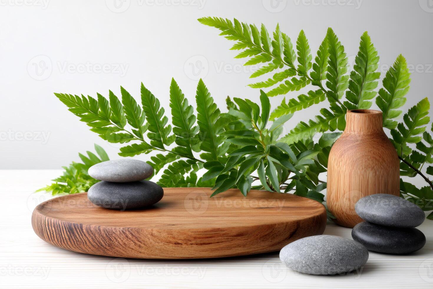 Composition of pebbles, wooden plate, vase and fern leaves creating relaxing atmosphere photo
