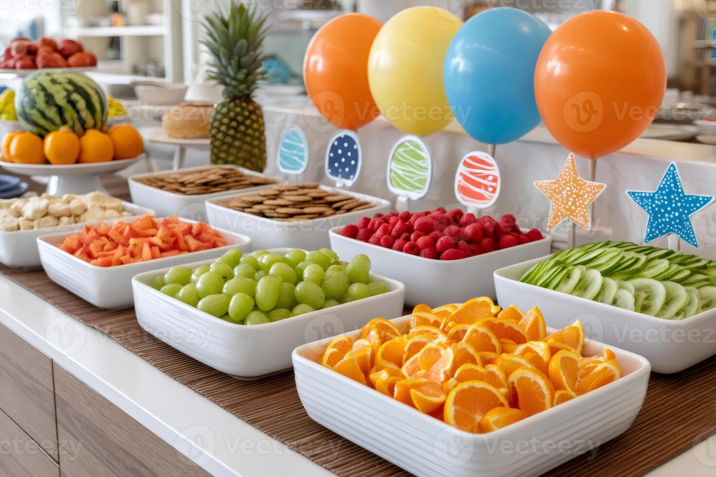 Colorful balloons decorating a table with fresh fruit platter for a children's party photo