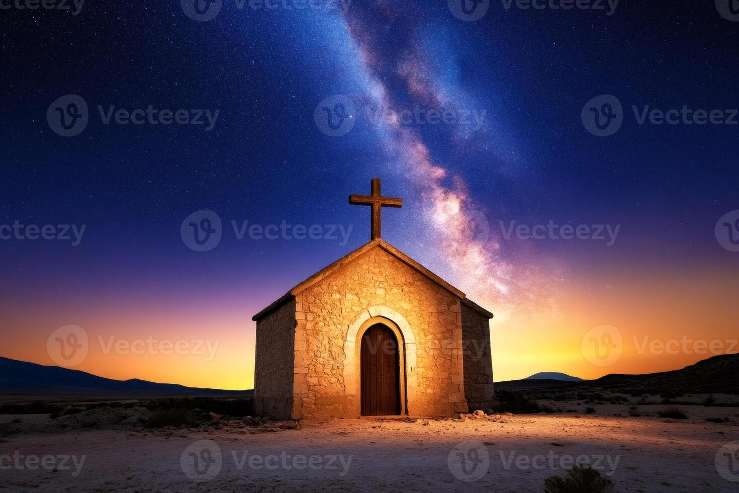 Small church standing alone in desert at sunset under milky way photo