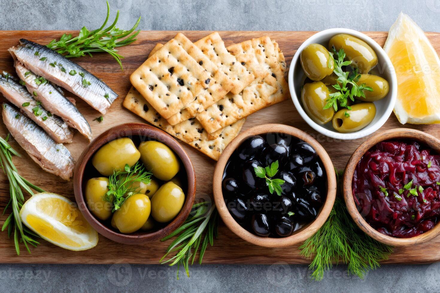Sprats, crackers, olives and beetroot salad creating delicious mediterranean appetizer platter photo