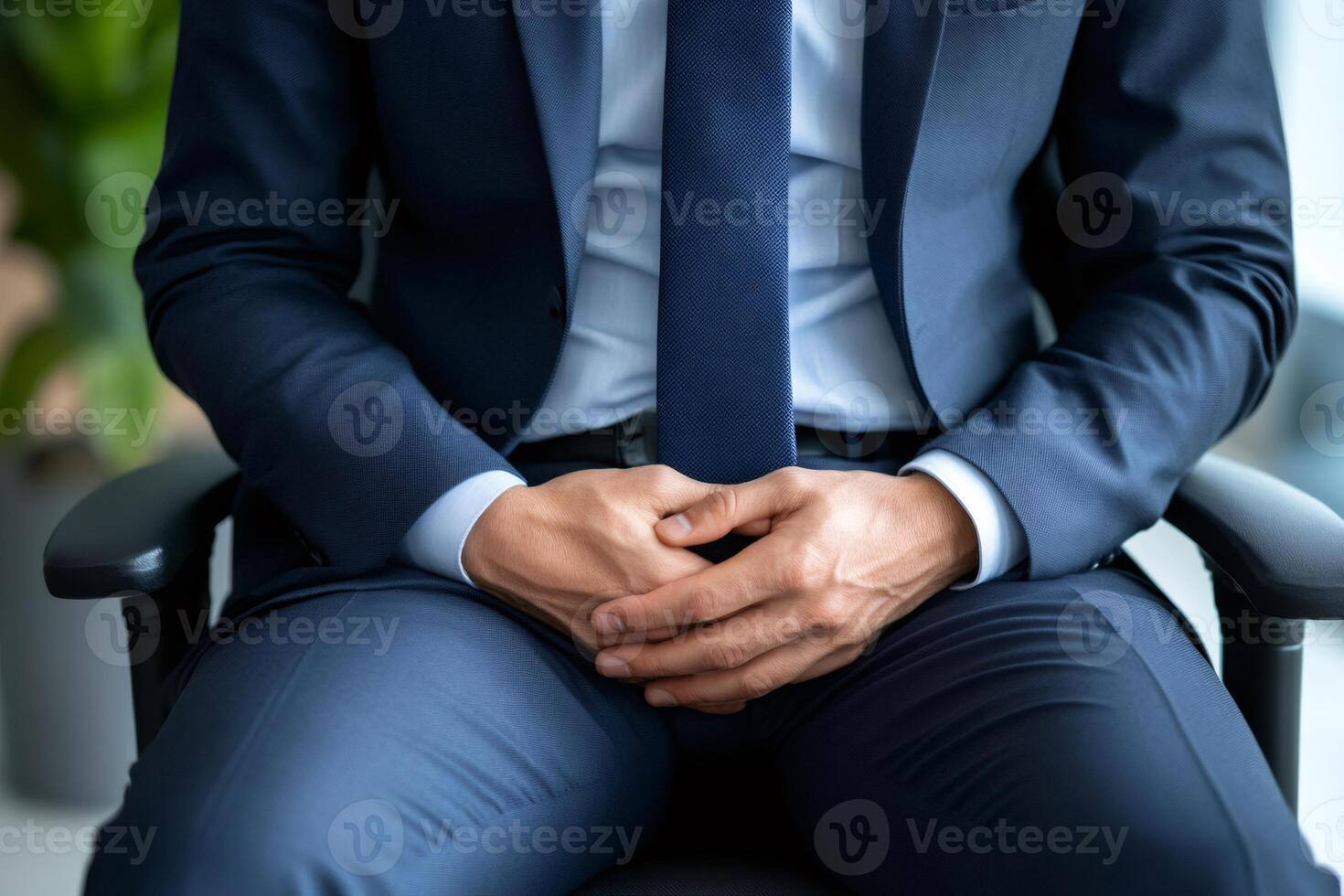 Businessman sitting on chair clasping hands, confidence and authority in corporate setting photo