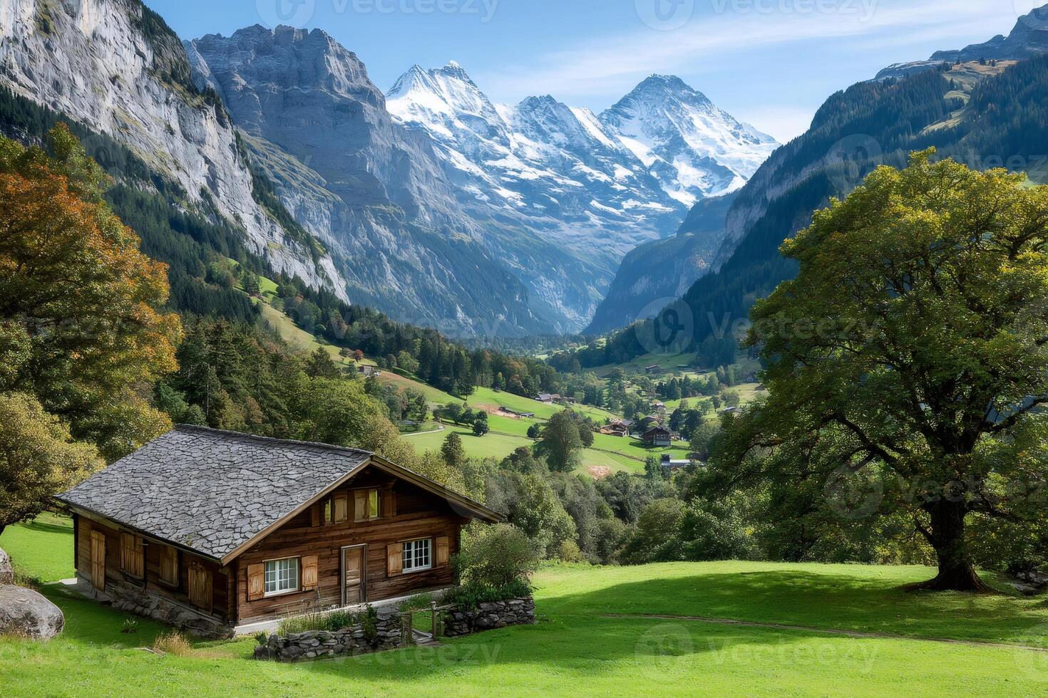 Wooden chalet overlooking picturesque valley in the swiss alps photo