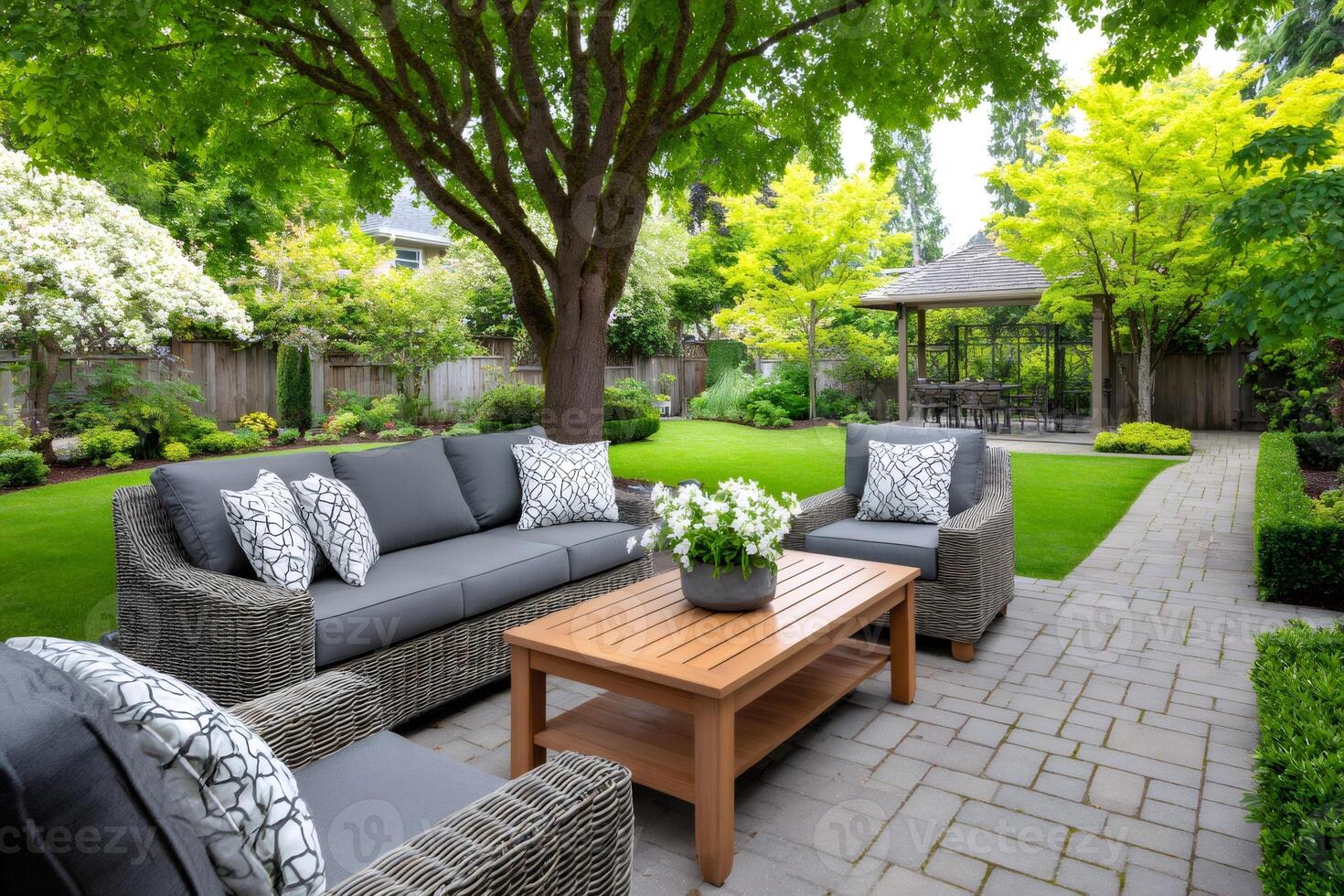 Backyard patio with comfortable furniture enjoying summer day photo
