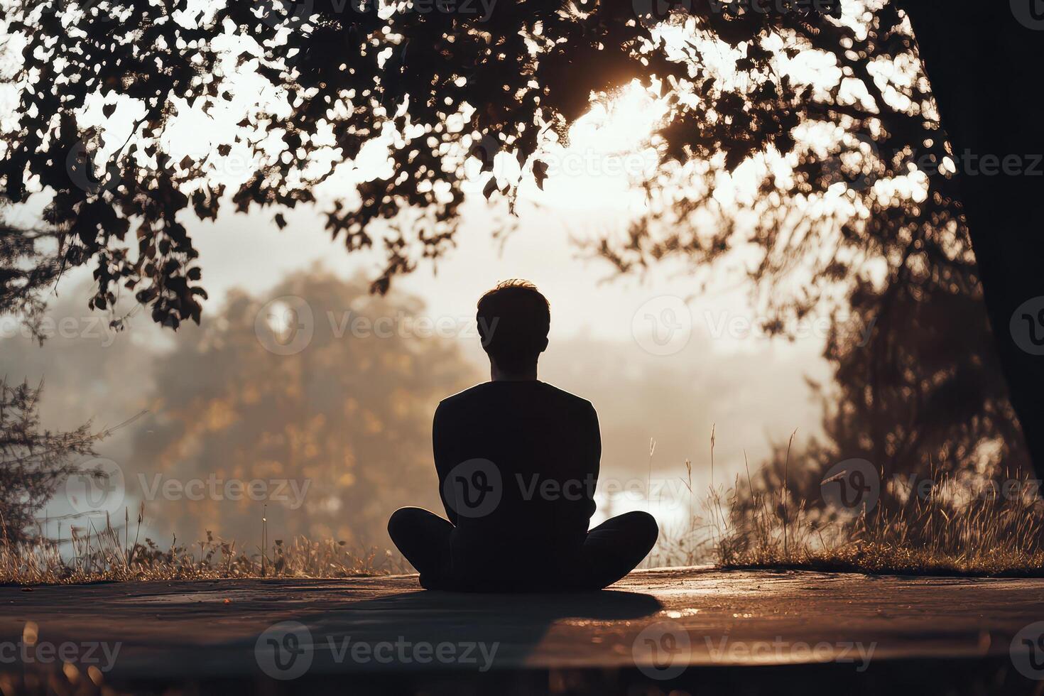 Relaxing meditation at sunset by the lake photo