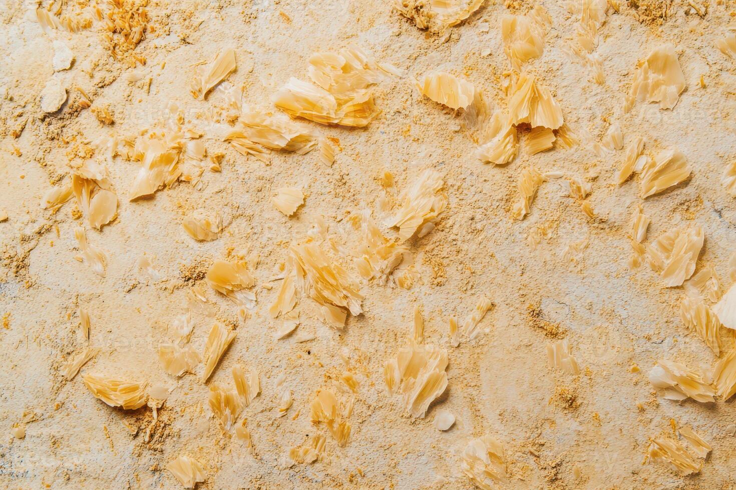 Natural yellow flour spread across a surface photo