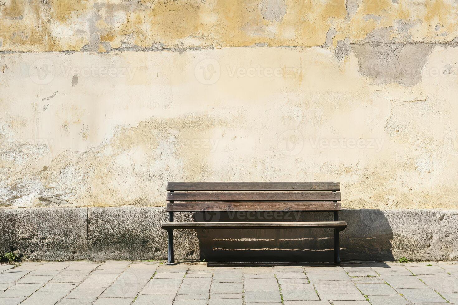 Wooden bench by a weathered wall photo