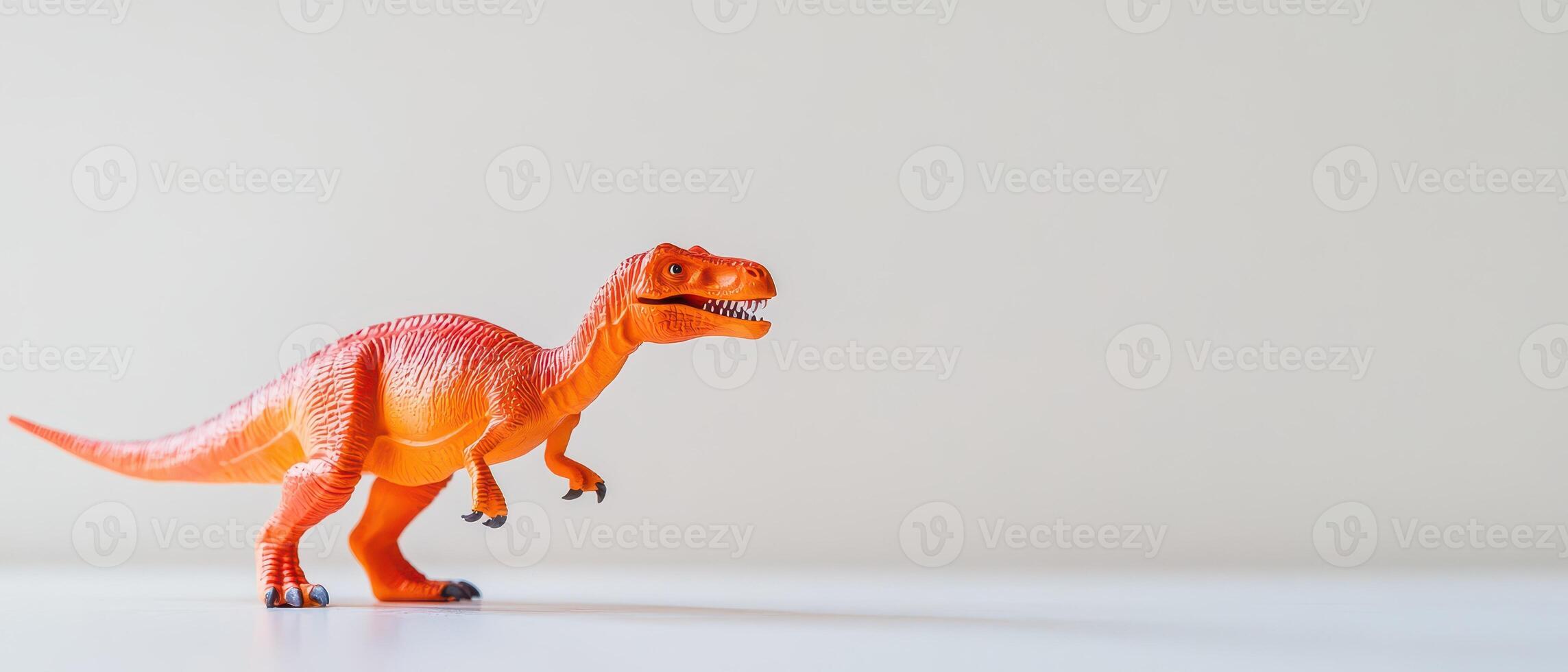 Orange dinosaur toy on white surface photo