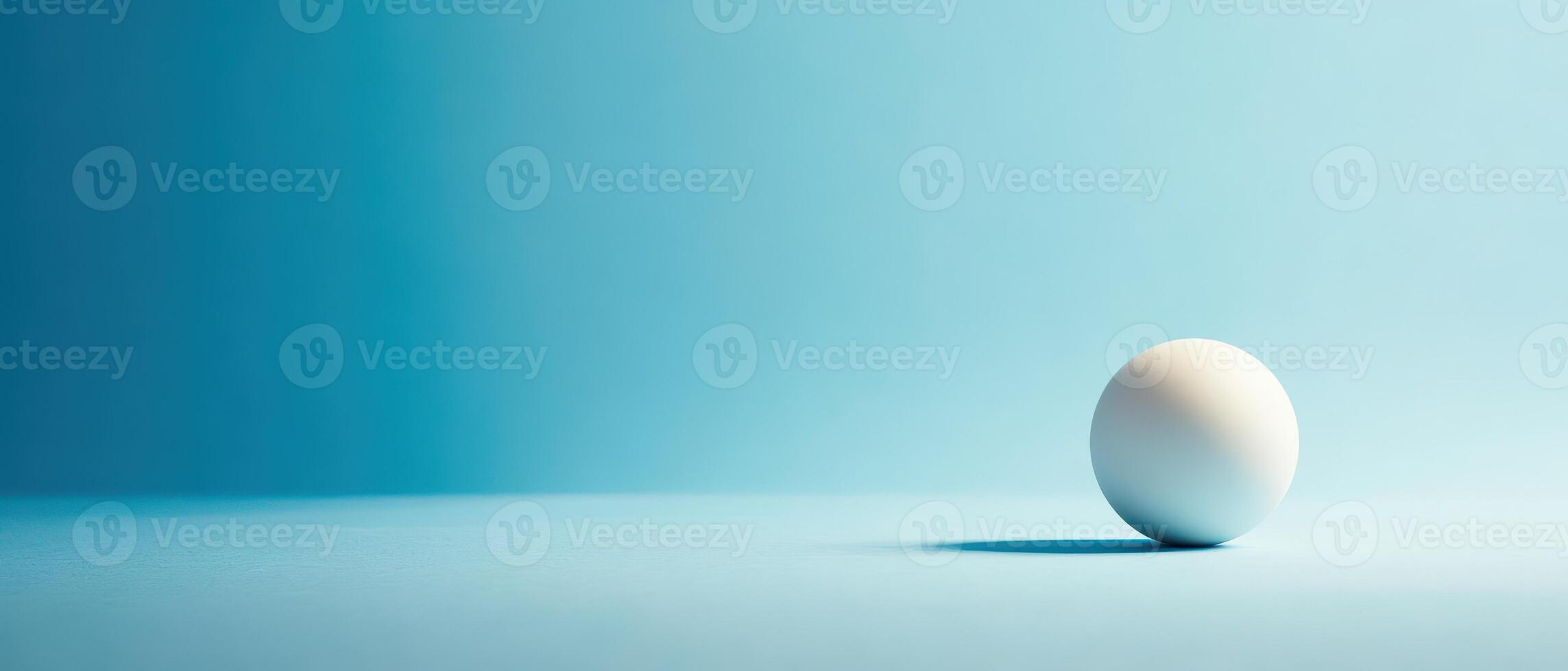 White sphere rolls on blue surface in soft light photo