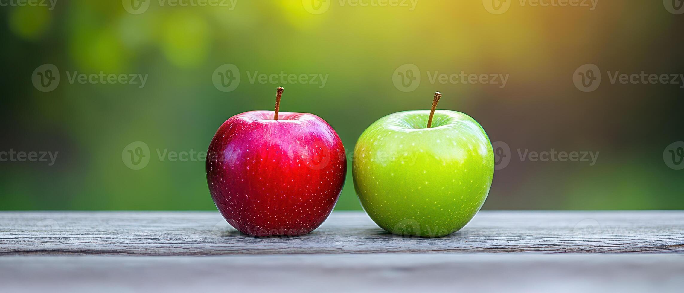 Fresh red and green apples on a wooden table photo