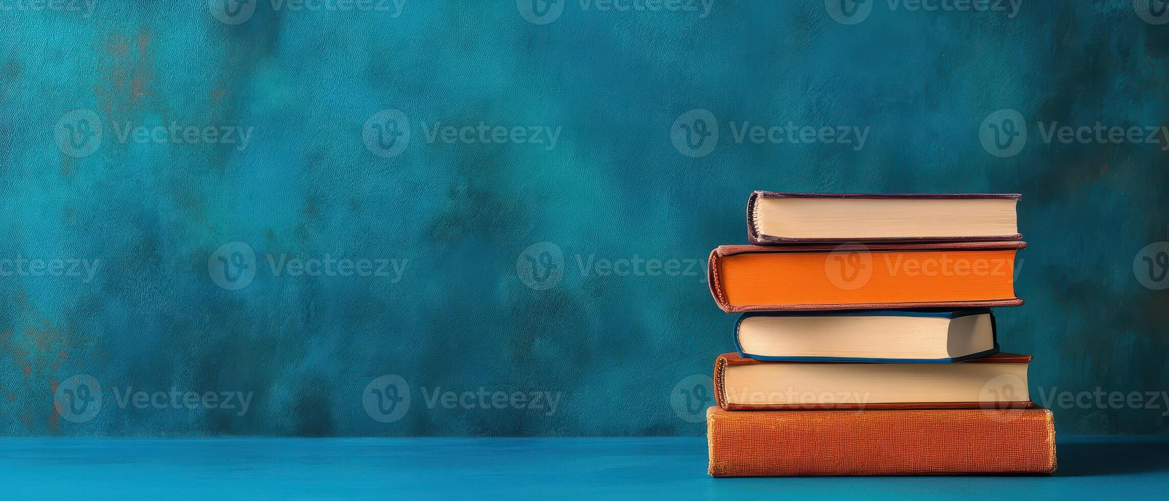 Stack of books on blue background photo