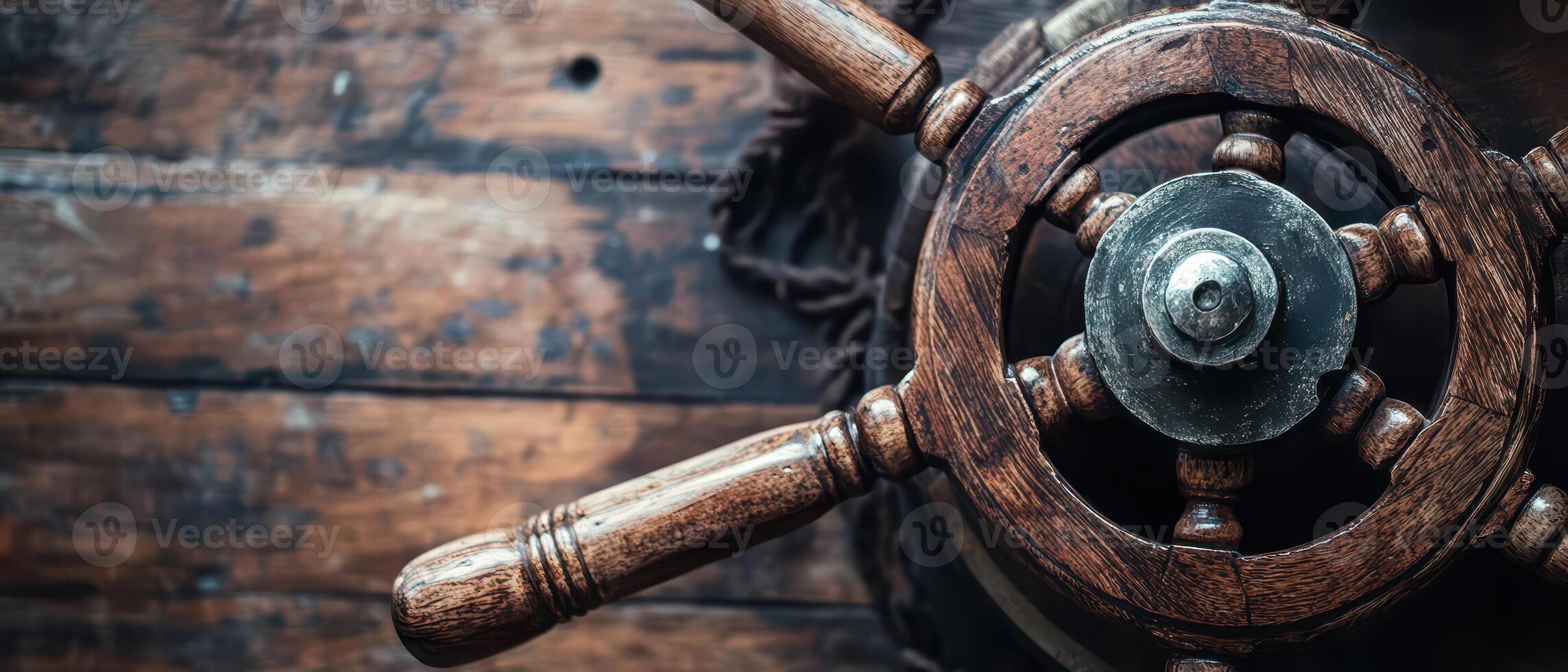 Old wooden ship wheel on a rustic surface photo