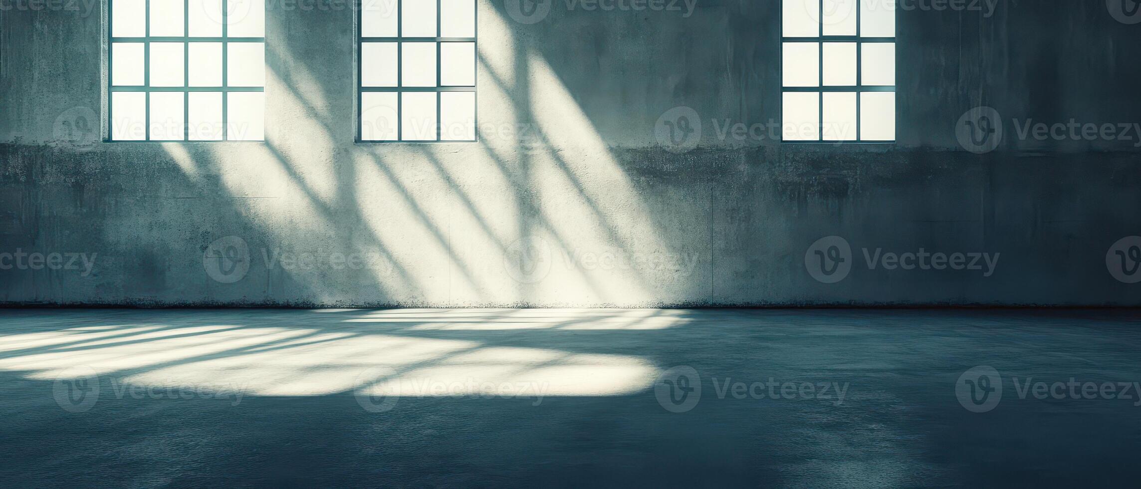 Light patterns dance on concrete in an empty space photo