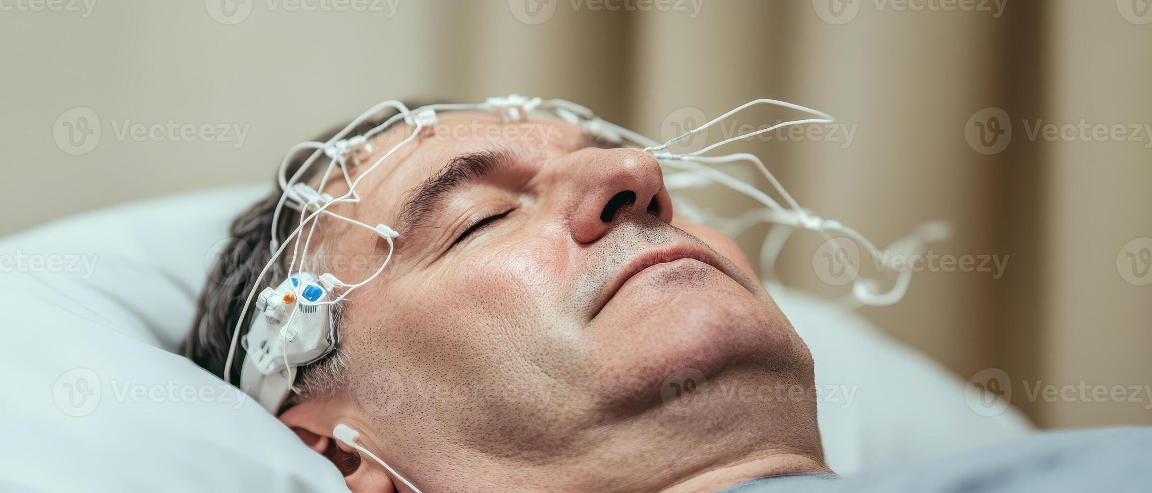 Man undergoing sleep study with electrodes applied photo