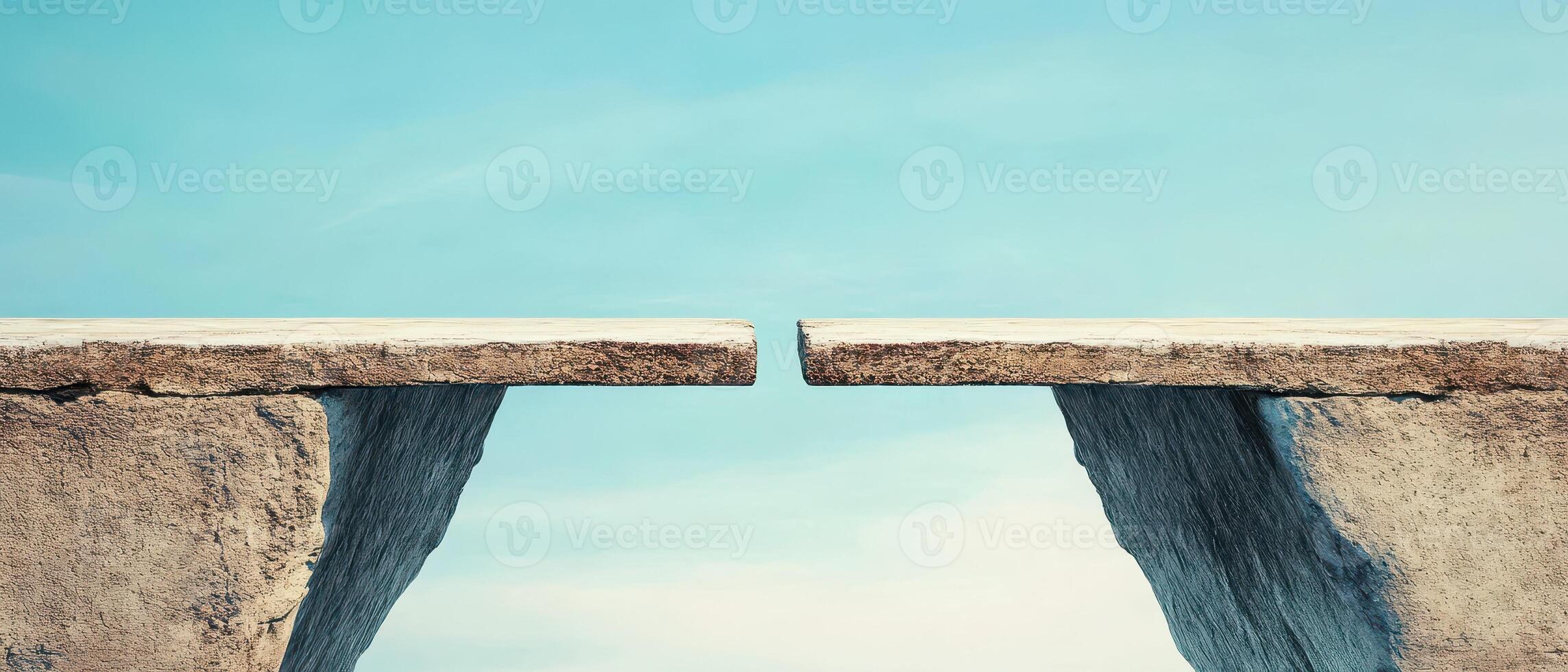 Two cliffs separated by a gap under a clear sky photo