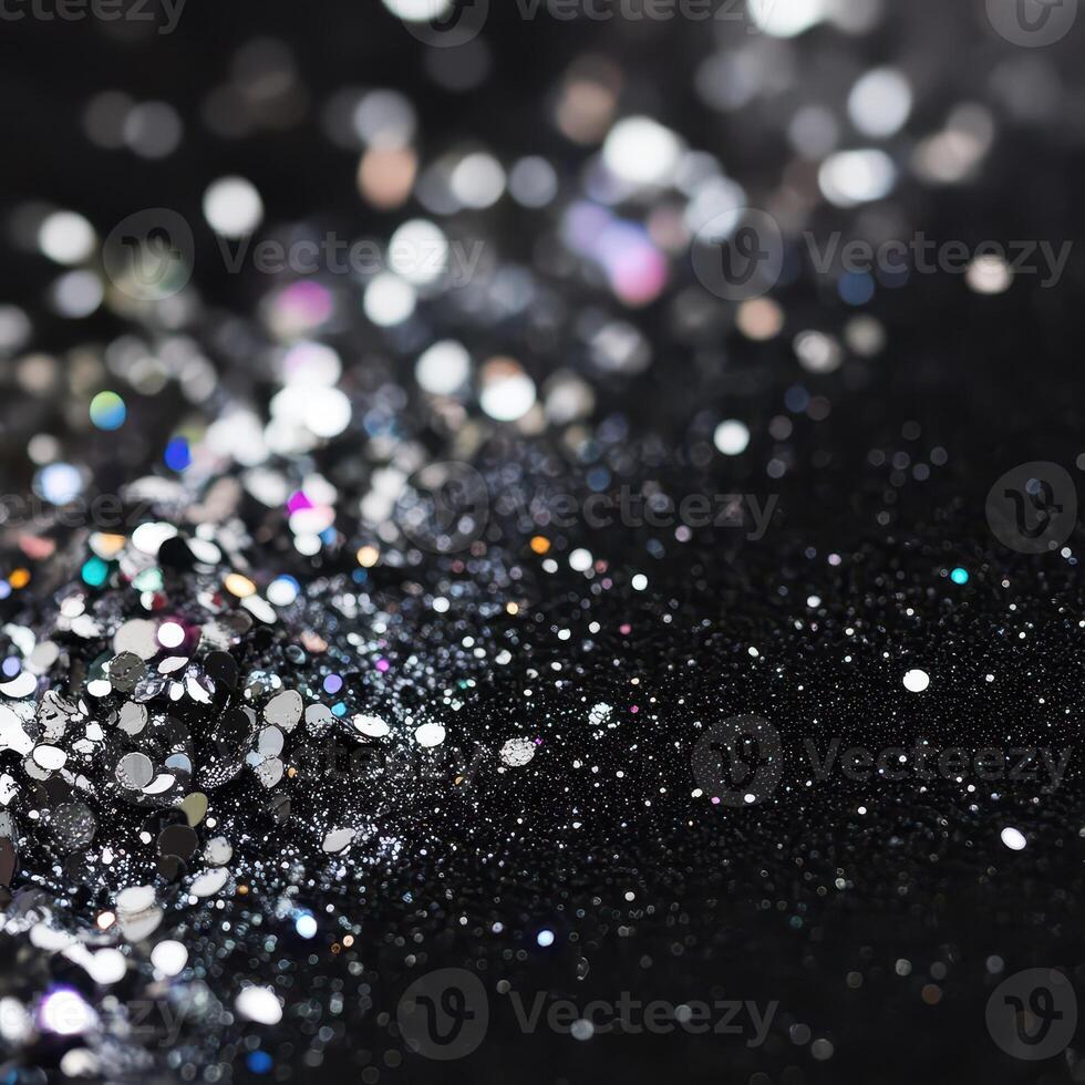 Sparkling glitter scattered on dark surface photo