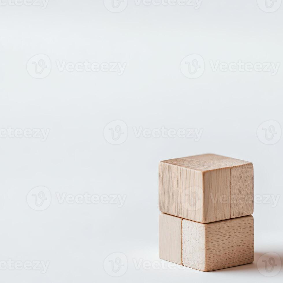 Wooden blocks stacked on a plain surface photo
