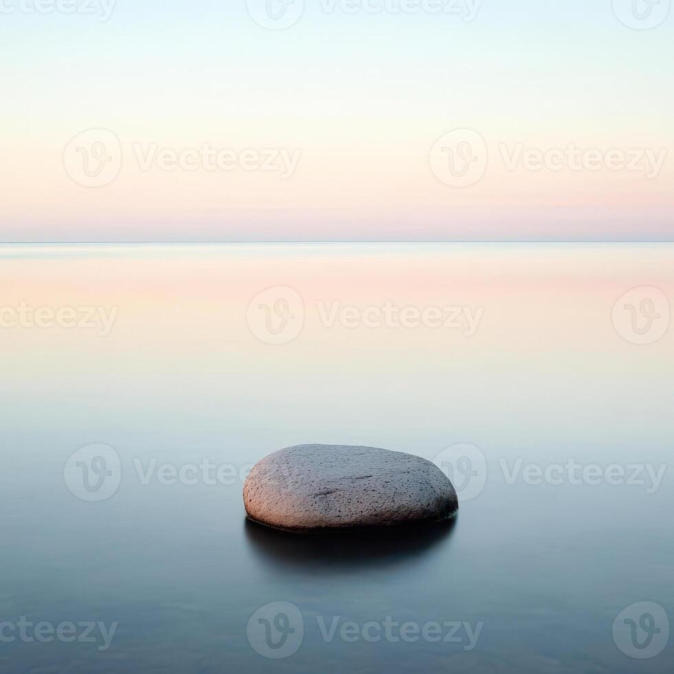 Calm waters reflect soft hues at dawn photo