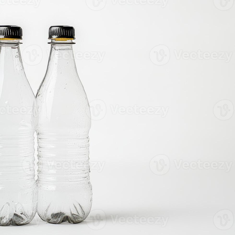 Two clear water bottles on a plain background photo