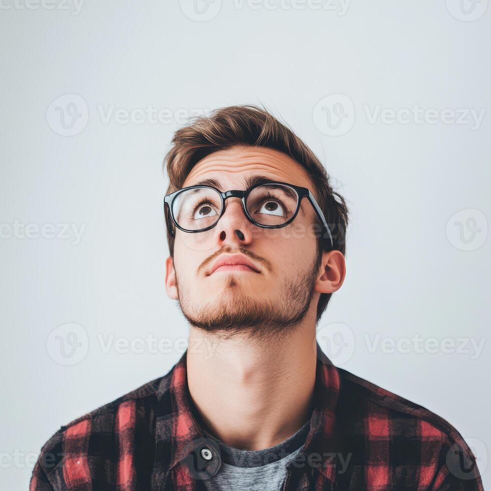 Man gazing upward with curiosity in casual outfit photo