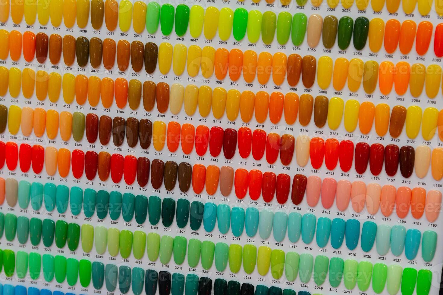 Set of many colorful palletes of gel nail polishes on counter of make up photo