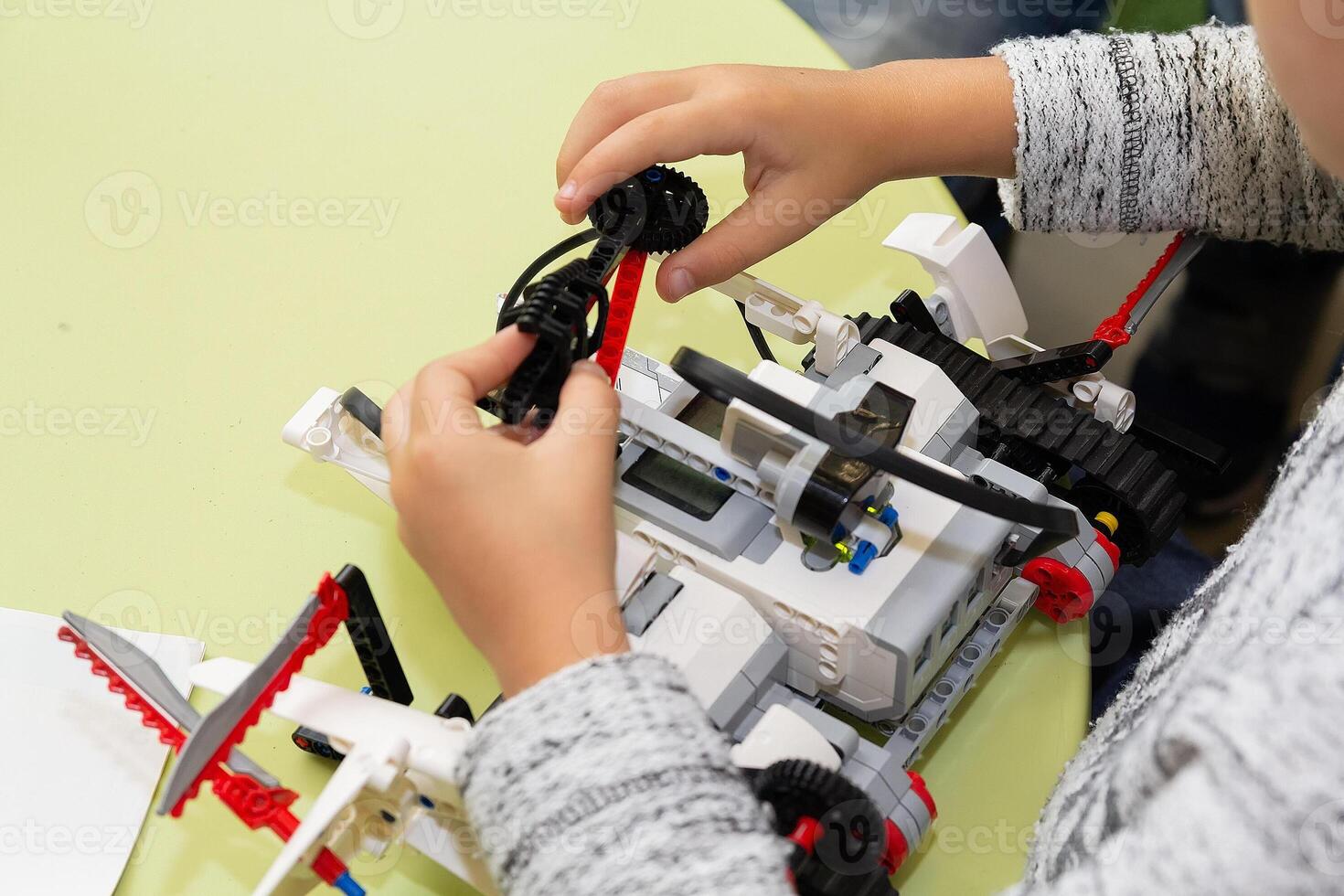 Children are working on model assembly in robotics class. Education photo