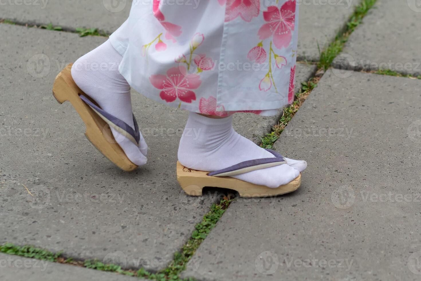 Girl in traditional Japanese wooden sandals photo