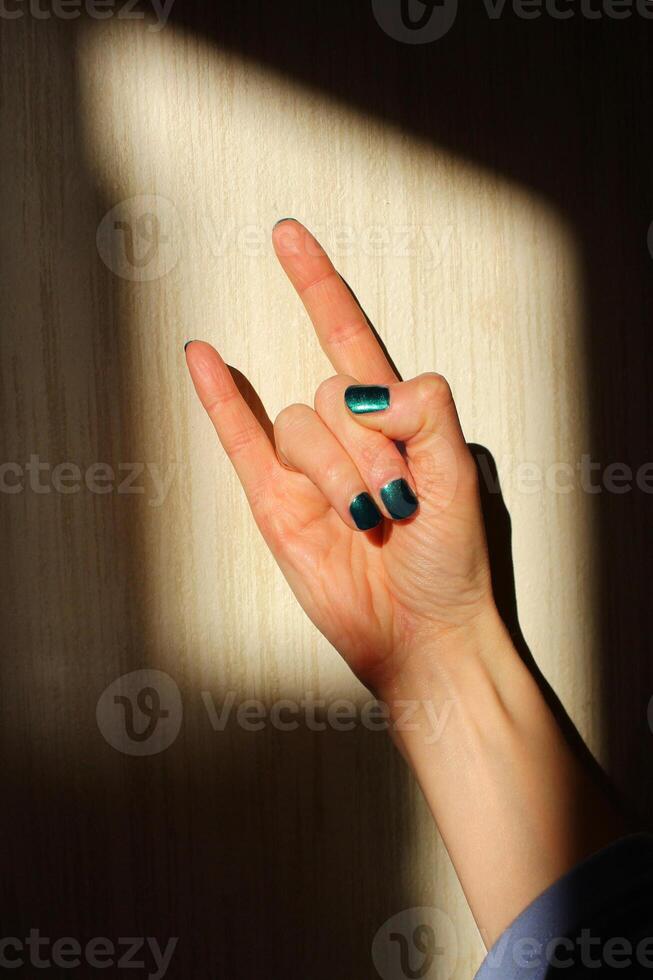 a hand showing a rock and roll sign or depicting the devil's horns. photo