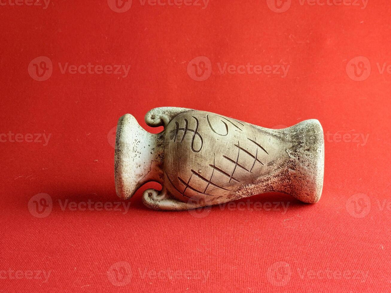 Antique ceramic decorative amphora on red background. Clay pot, set of the antique utensils for gardening and interior photo