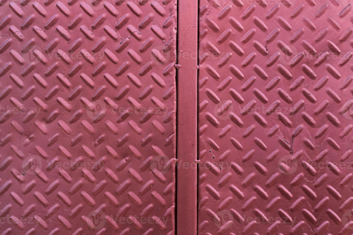 A close up of a red metal door with a diamond pattern photo