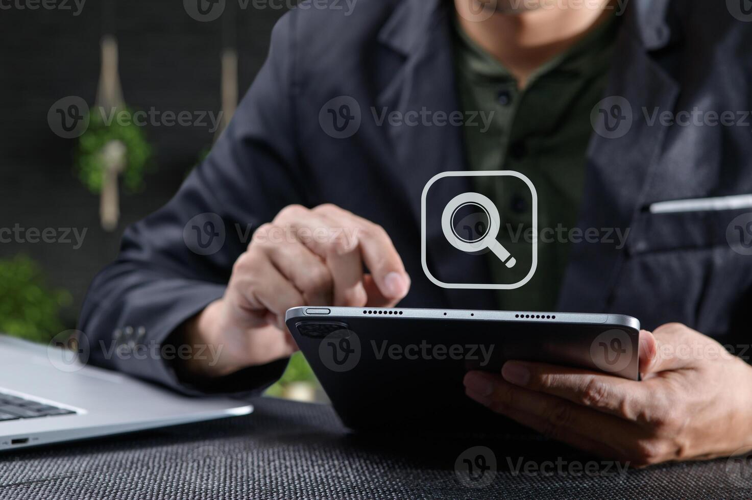 Man Using Tablet with Search Icon for Information Online photo