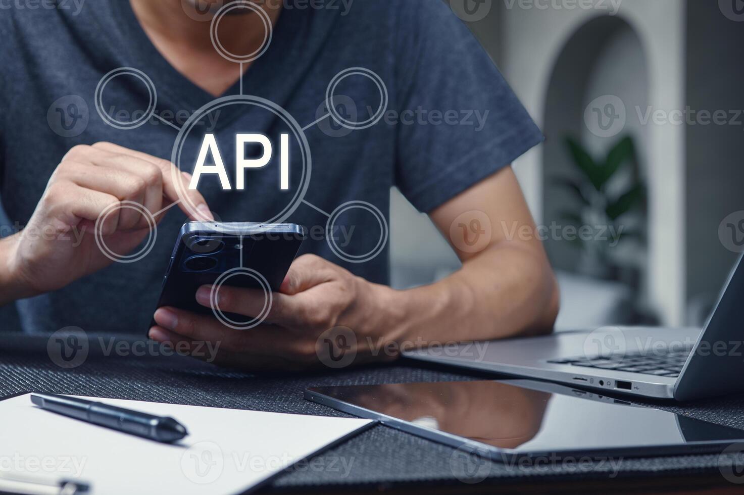 Man Using Smartphone with API Interface Concept Overlaid photo