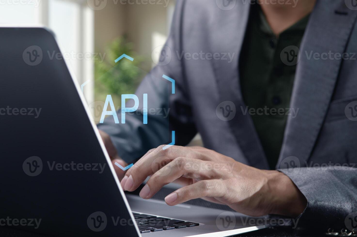 Hands Typing on Laptop with API Concept in Focused Workspace photo