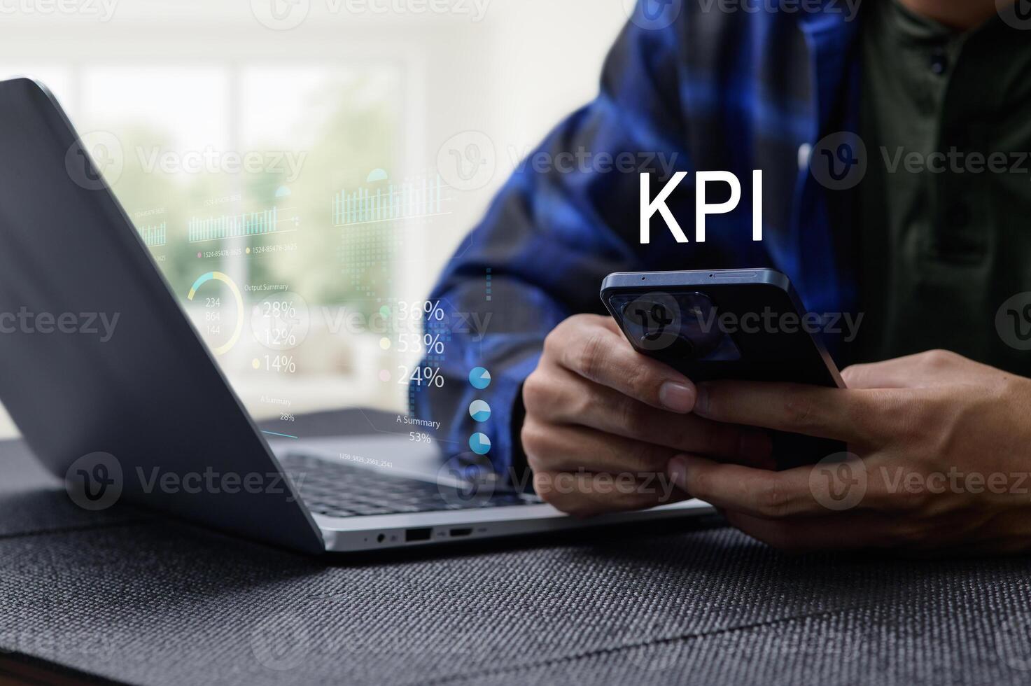 Businessman Analyzing KPI Performance with Laptop and Smartphone photo