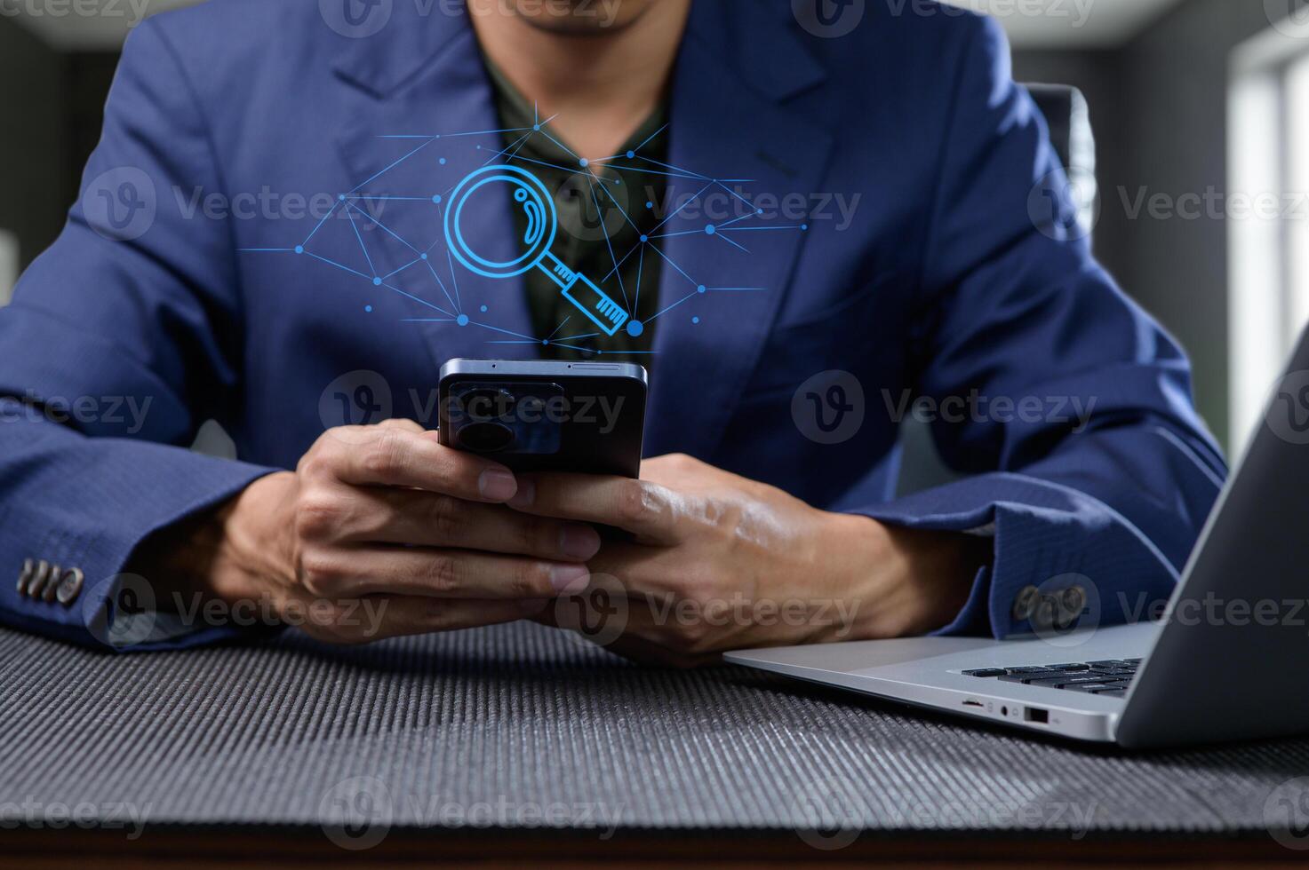 Person Searching for Information Online with Smartphone and Laptop photo