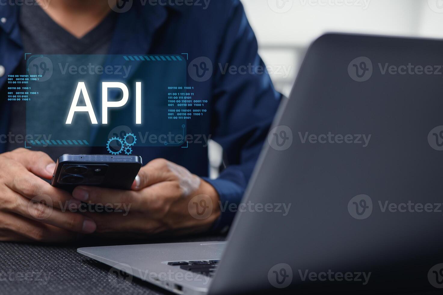 Developer Working on Mobile API Interface with Laptop and Phone photo