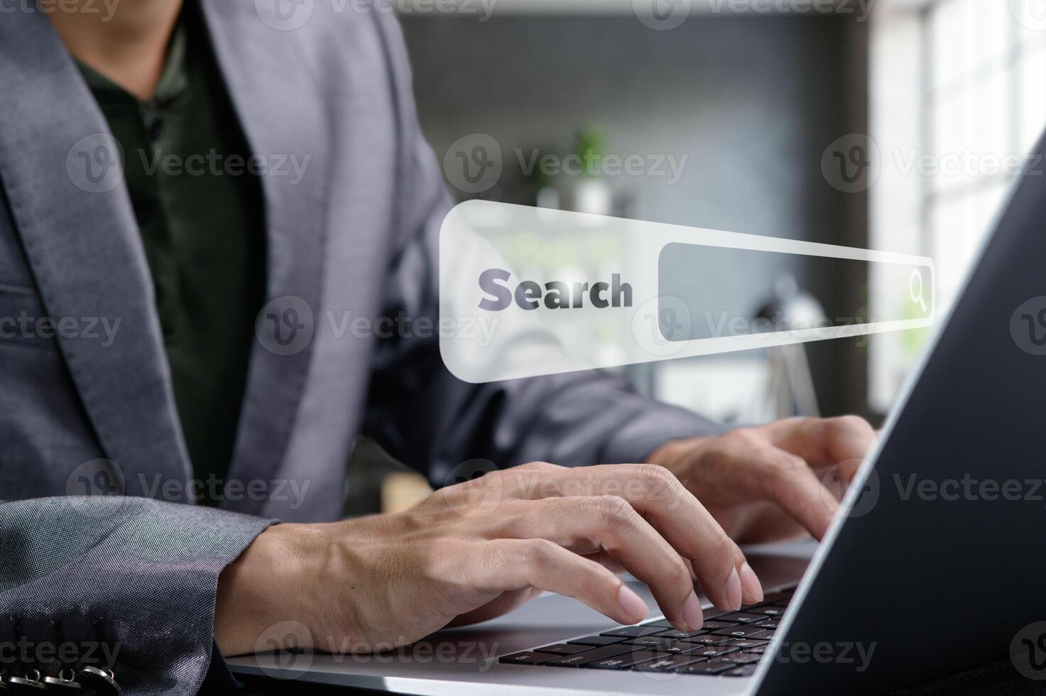 Businessman Using Laptop for Online Searching in Modern Office Space photo