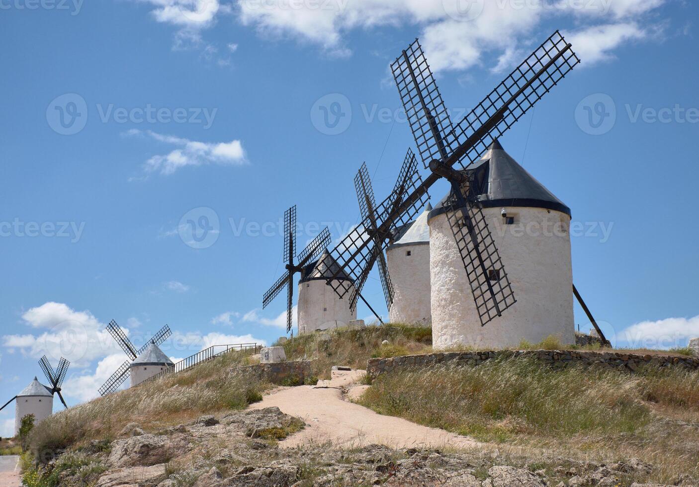 White windmills on a hill in La Mancha, Spain photo