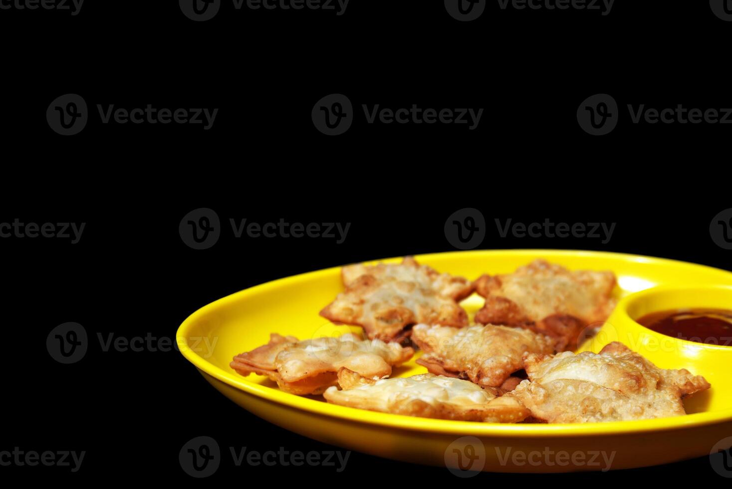 Delicate Starry Aloo Puffs Resting on Glossy Black Marble with Velvety Tomato Sauce - A Must-Have Gourmet Snack photo