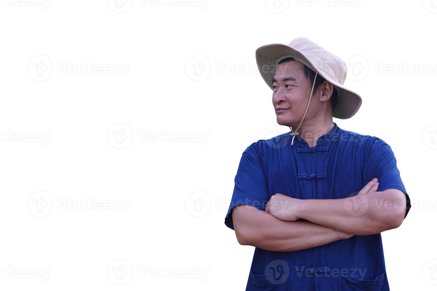 Handsome Asian man farmer wears a traditional hat and blue shirt, standing confidently with arms crossed on chest, isolated on white background. Concept Thai agriculture occupation and rural identity photo