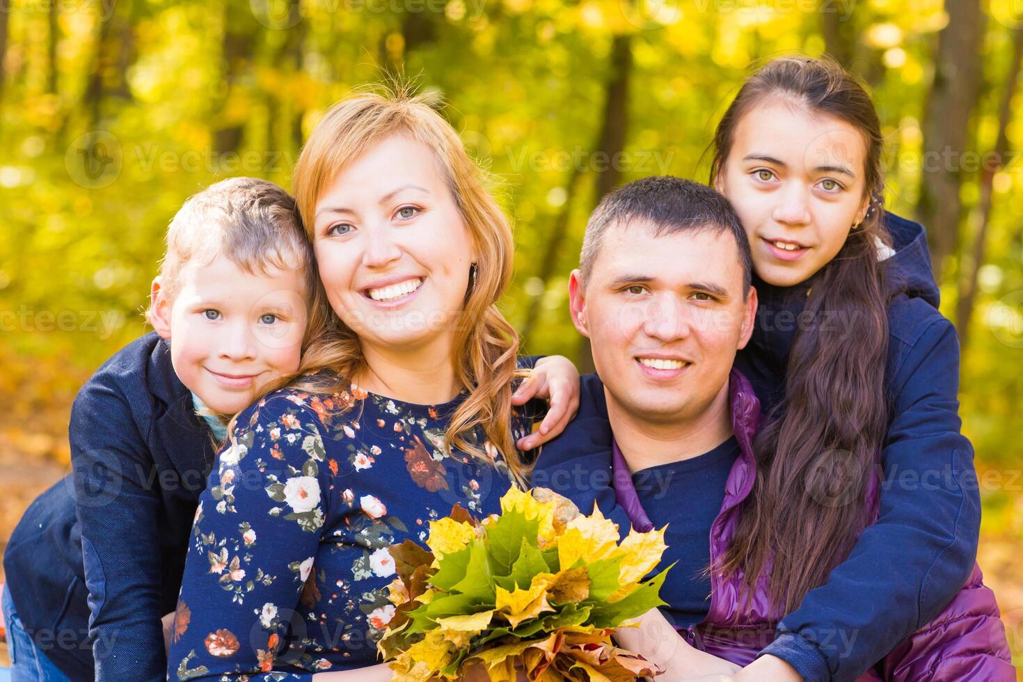 portrait of a young family in the autumn park photo